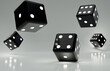 black dice falling on a glossy surface