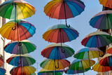 Fototapeta Tęcza - colorful umbrellas in the clouds as the main background