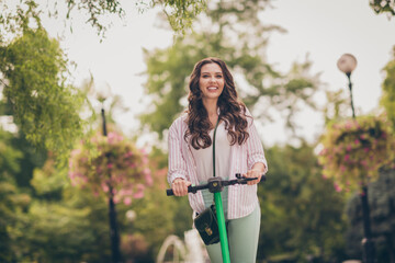 Sticker - Photo of beautiful young happy girl curly hair ride electric scooter fun enjoy outside wear casual outfit