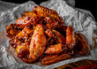 © pavel siamionov - fried chicken wings with sweet chili sauce on white paper
