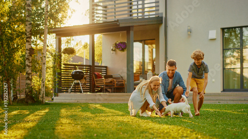 Fotografía Smiling Father, Mother and Son Pet and Play with Smooth Fox Terrier Retriever Dog