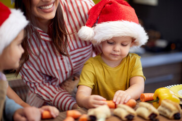 A little boy playing in the kitchen at Xmas meal preparation. Christmas, family, together