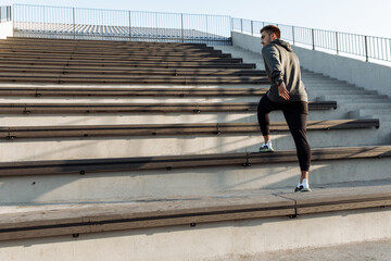 Sporty man, in sportswear, jogging while training outdoors on the city stairs, sport, healthy lifestyle