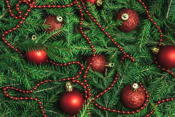 Wall Mural - Background texture of Christmas tree branches with red baubles and beads