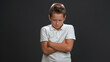 © Svyatoslav Lypynskyy - Angry schoolboy crossed hand frowning face. Isolated on gray background. Copy space.