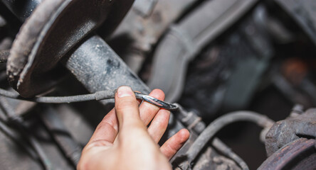 frayed wire of the anti-lock braking system abs sensor and brake pad wear. Cause of system breakdown abs.