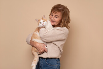 Mature caucasian woman with glasses holding a cat