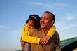 © saptak Ganguly/Stocksy - Little girl riding on her grandfather's back and having fun