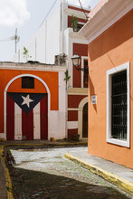 Puerto Rican Flag Mural On Bright Orange Wall From A Colonial Home