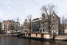 Canal With Houses In Amsterdam