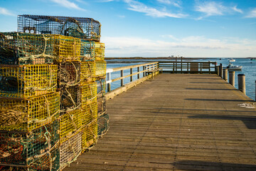 A stack of lobster traps and rope tied together on a fishing pier in Cape Porpoise, Maine.