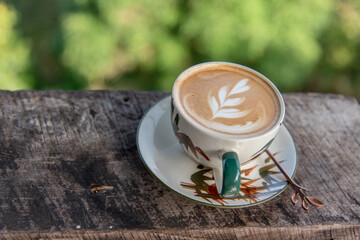 Latte Art on a hot latte in a ceramic cup on a table.