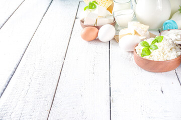 Wall Mural - Set of Various Fresh Dairy Products - milk, cottage cheese, cheese, eggs, yogurt, sour cream, butter on wooden background