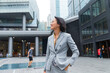© Bo Bo/Stocksy - Pretty Asian businesswoman in the city portrait