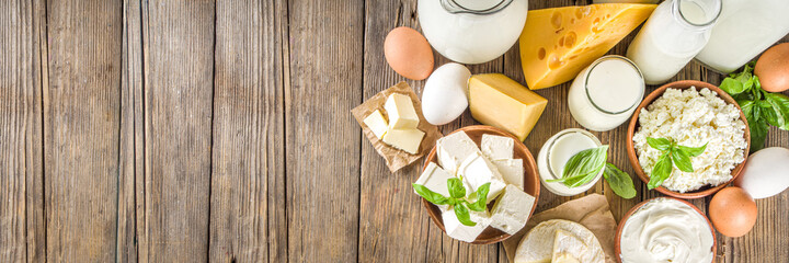 Wall Mural - Set of Various Fresh Dairy Products - milk, cottage cheese, cheese, eggs, yogurt, sour cream, butter on wooden background