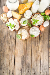 Wall Mural - Set of Various Fresh Dairy Products - milk, cottage cheese, cheese, eggs, yogurt, sour cream, butter on wooden background