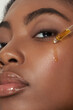© HANNAH CRISWELL/Stocksy - Model with face serum dripping on face