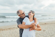 © Isabel Alcaine/Stocksy - Retired couple hugging on the seashore