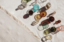 Colorful Glass Cups, Bottles, And Jars On Canvas Cloth