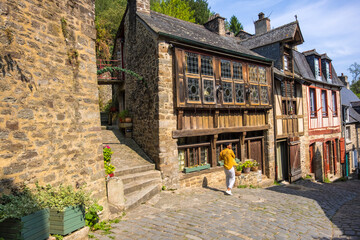 Wall Mural - Dinan, France - August 26, 2019: View of historic colombage half-timbered and stone houses on the street rue du Petit Fort in Dinan, French Brittany