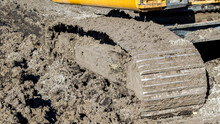 A Filthy Metal Bulldozer Track Stuck In The Mud