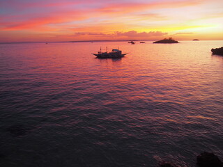 Wall Mural - Amazing and beautiful sunsets, Dusk sky in the evening, Ships and Islands in the Sea, The sky is changing to a purple color, Malapascua Island, Daanbantayan, Philippines