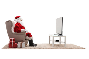 Wall Mural - Santa claus watching tv with presents on the floor