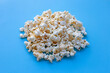 © Bowonpat - Popcorn on blue background. Copy space