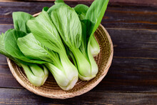 Fresh Bok Choy Or Pak Choi(Chinese Cabbage) In Bamboo Basket On Wooden Background, Organic Vegetables