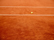 Ball for tennis laying on a red tennis clay court