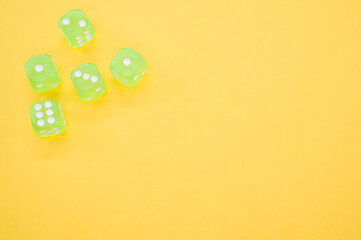 Wall Mural - Top view closeup of five neon green dice isolated on a yellow background