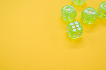 Wall Mural - Top view closeup of five neon green dice isolated on a yellow background