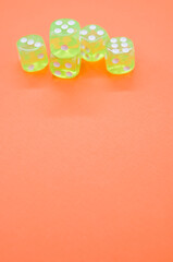 Wall Mural - Top view closeup of five neon green dice isolated on an orange background