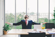 © nikomsolftwaer - young successful businessman, Successful business man spreading arms. Happy young man working on laptop while sitting at his working place in office