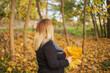 © GALINA - Young blonde woman walk in an autumn park. Fall time.