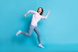 © deagreez - Full body profile side photo of energetic girl run fast after season sales wear violet purple pullover gumshoes isolated over blue color background