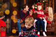 © Monstar Studio - Parents and children opening Christmas gifts. Christmas tradition. Boxing day. Happy holidays. Father man and mother with cute daughters Christmas tree background. Spend Christmas time with family
