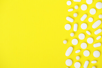 Wall Mural - Bright yellow background with white medicine tablets