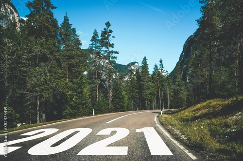 2021 New Year road trip travel and future vision concept . Nature landscape with highway road leading forward to happy new year celebration in the beginning of 2021 for fresh and successful start .