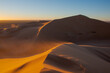 Wide angle shoot of sand desert dunes of Erg Chigaga moved by the wind. The gates of the Sahara, at sunrise. Morocco. Concept of travel and adventure