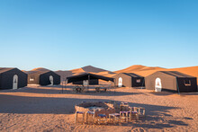 Desert Camp And Campfire In Dunes Of Erg Chigaga, At The Gates Of The Sahara. Morocco. Concept Of Travel And Adventure.