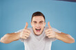 © SHOTPRIME STUDIO - Emotional man in white t-shirt cropped view on blue background lifestyle