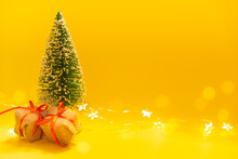 Yellow Christmas Background. Christmas Tree With Gifts And Copy Space