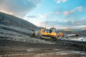 Wall Mural -    Bulldozers at work. Mining.
Bulldozers cut the topsoil in a mountainous forested area. Mining