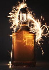 Whiskey bottle on festive fire background