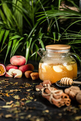 Fruit hot tea with the addition of oranges, lemons, mandarins and raspberries in a glass cups on a table. Healthy hot drink. tea with fruit and berries in a glass teapot. tea for colds.