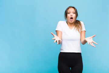 Wall Mural - young hispanic woman feeling extremely shocked and surprised, anxious and panicking, with a stressed and horrified look