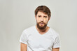 © SHOTPRIME STUDIO - man in white t-shirt gesturing with his hands studio dissatisfaction lifestyle light background
