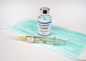 COVID-19 vaccine bottle and syringe and treatment from coronavirus infection.Selective focus on  vaccine bottle.