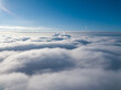 © Sergey - Aerial view. Flying over white clouds during the day in sunny weather.